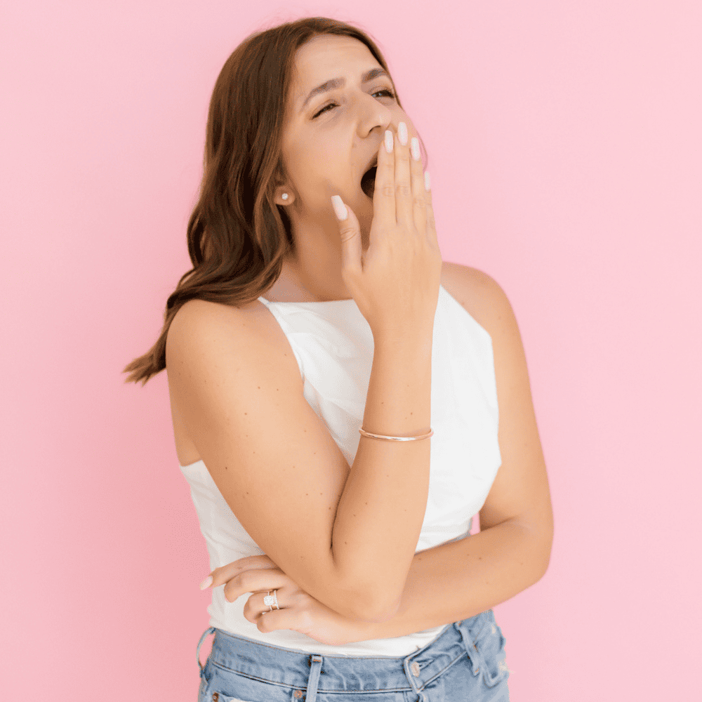 Woman standing while yawning Woman is standing while yawning