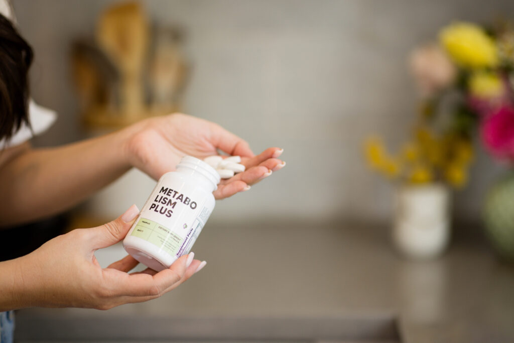 pouring OvaFit's multivitamin in her hand