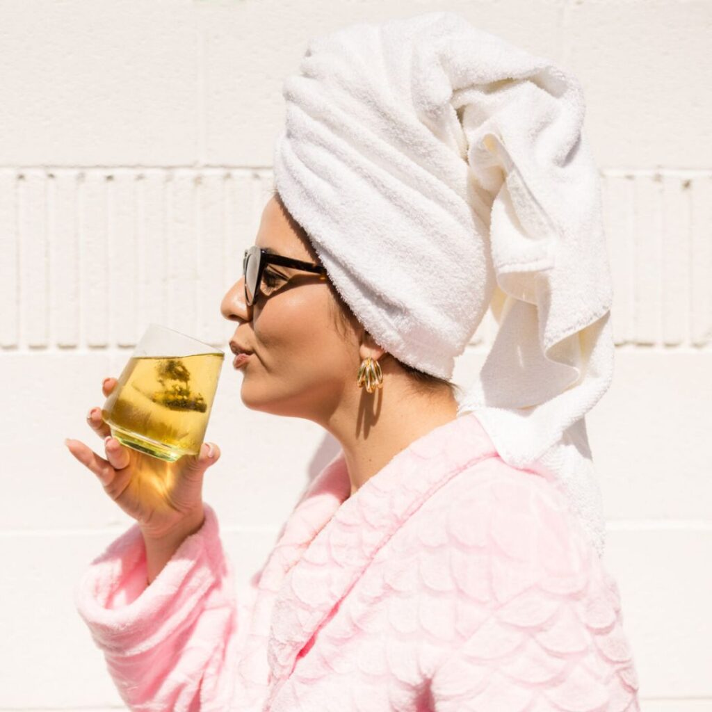 Woman drinking a glass of hormone balancing tea