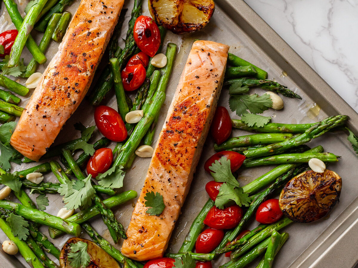 sheet pan with slices of salmon and roasted asparagus