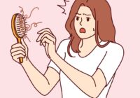 cartoon woman holding brush full of her hair after brushing