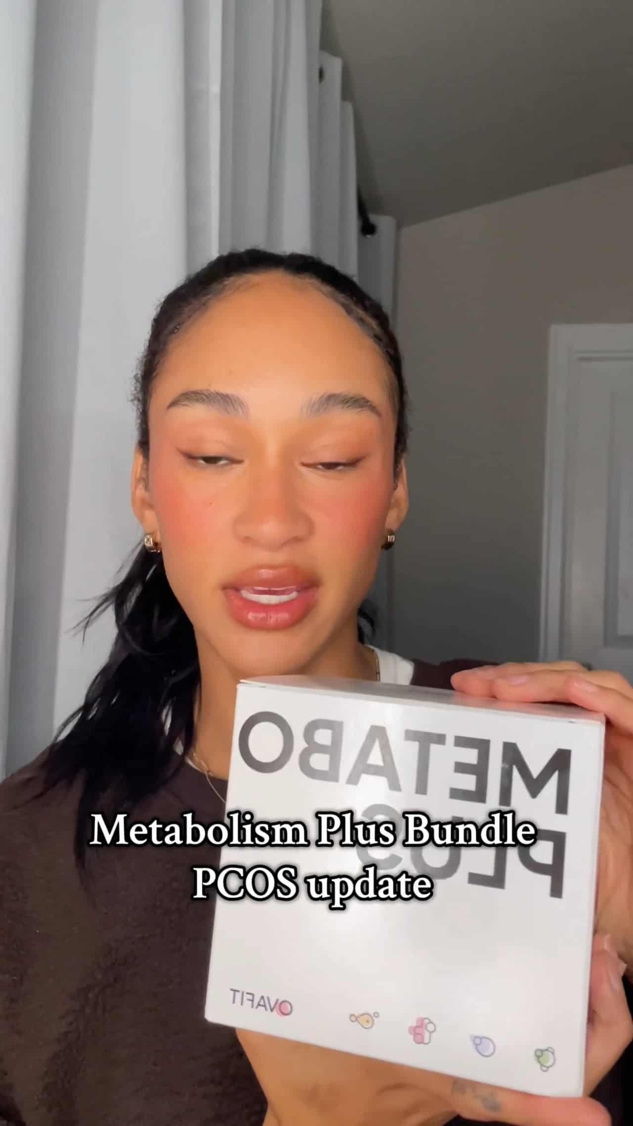 woman holding a package of metabolism plus supplements giving a testimonial