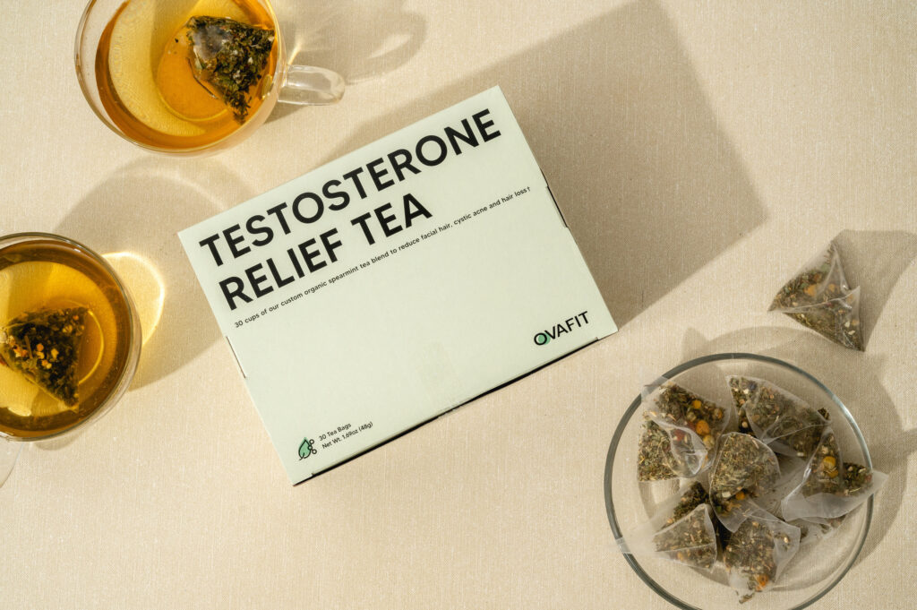 testosterone relief tea box of testosterone relief tea next to two cups of tea and a cup of tea sachets
