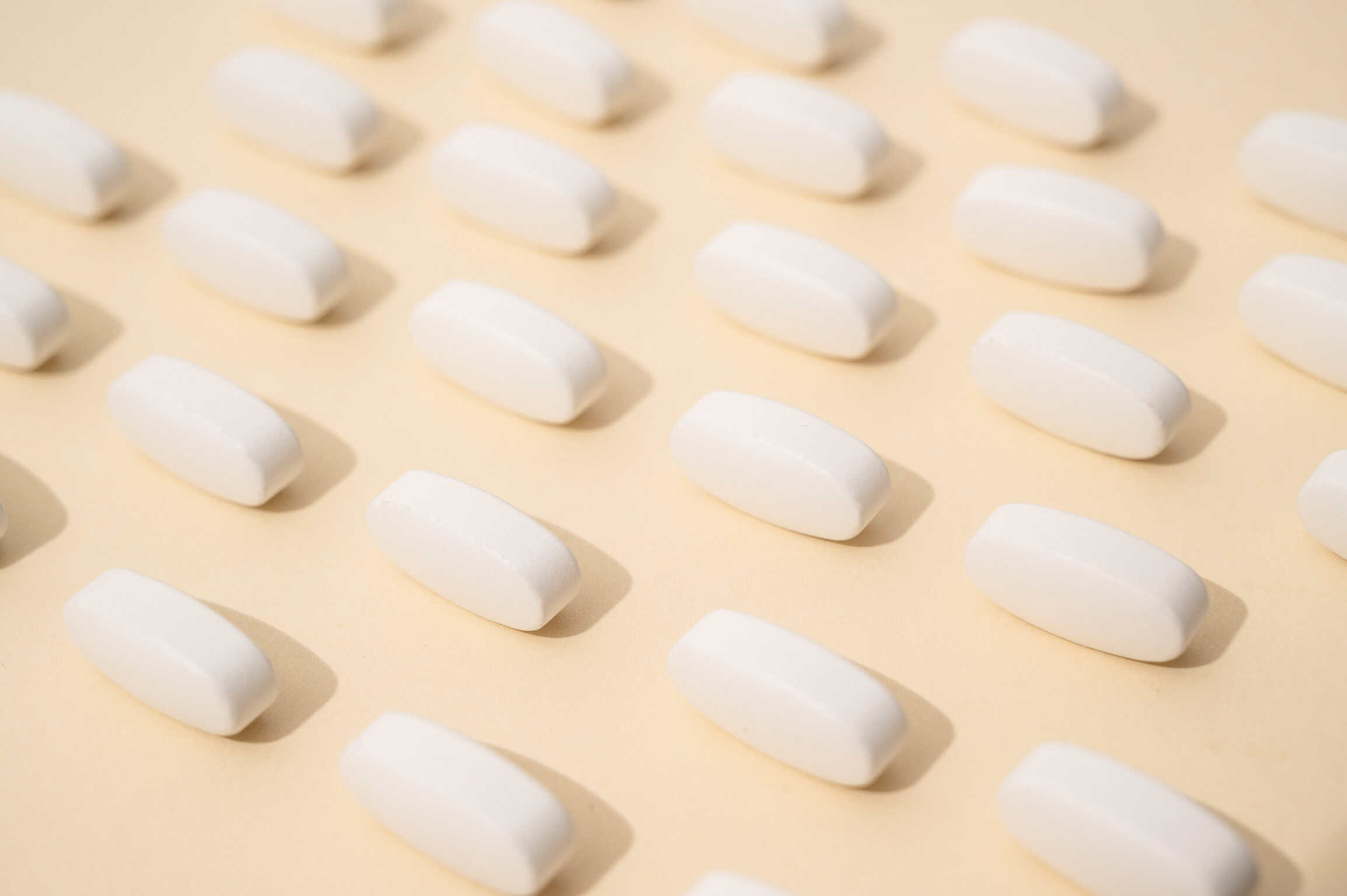 pills laid out on a beige background