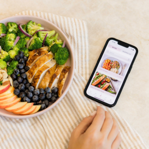 a phone showing recipe categories with a pcos friendly meal next to it